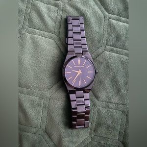 Women’s black and gold Michael Kors watch
